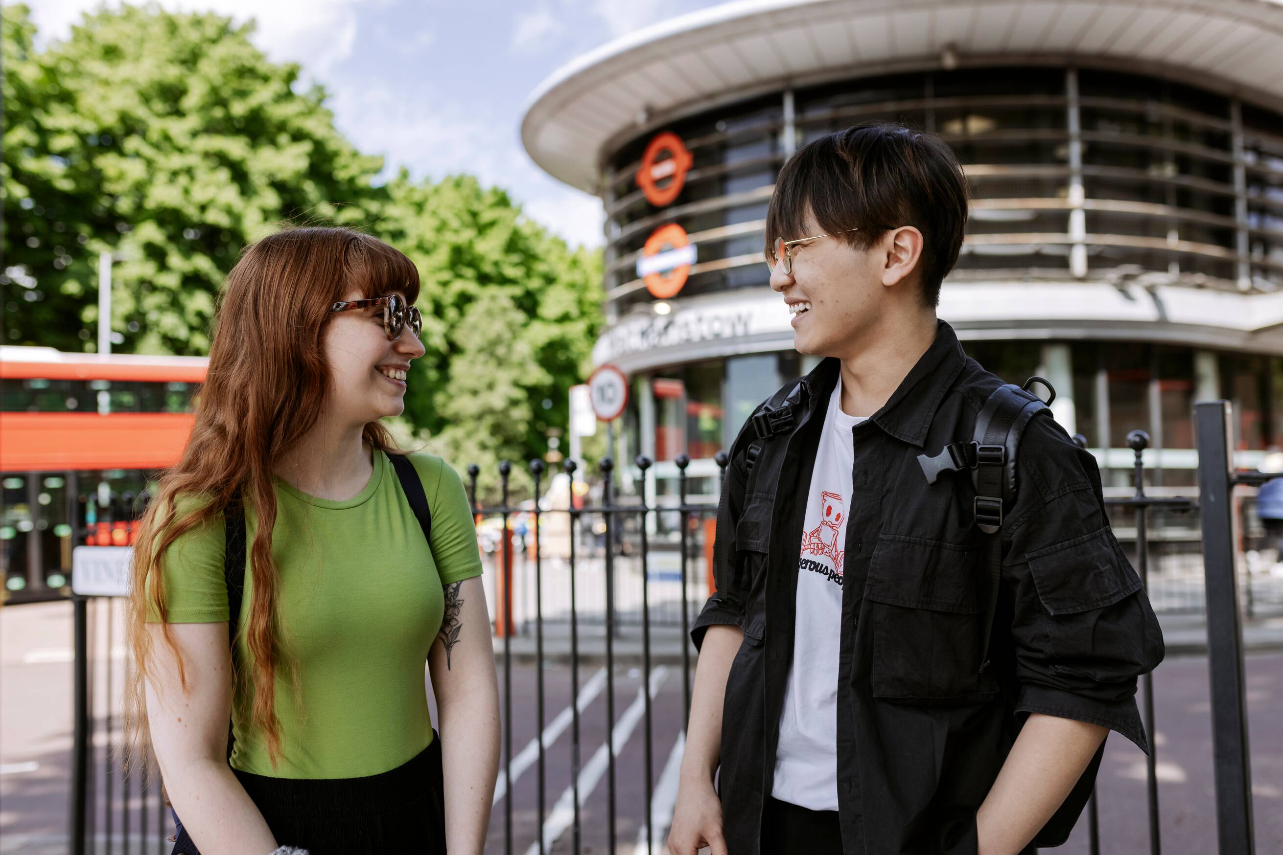 Students talking in front of a tube station